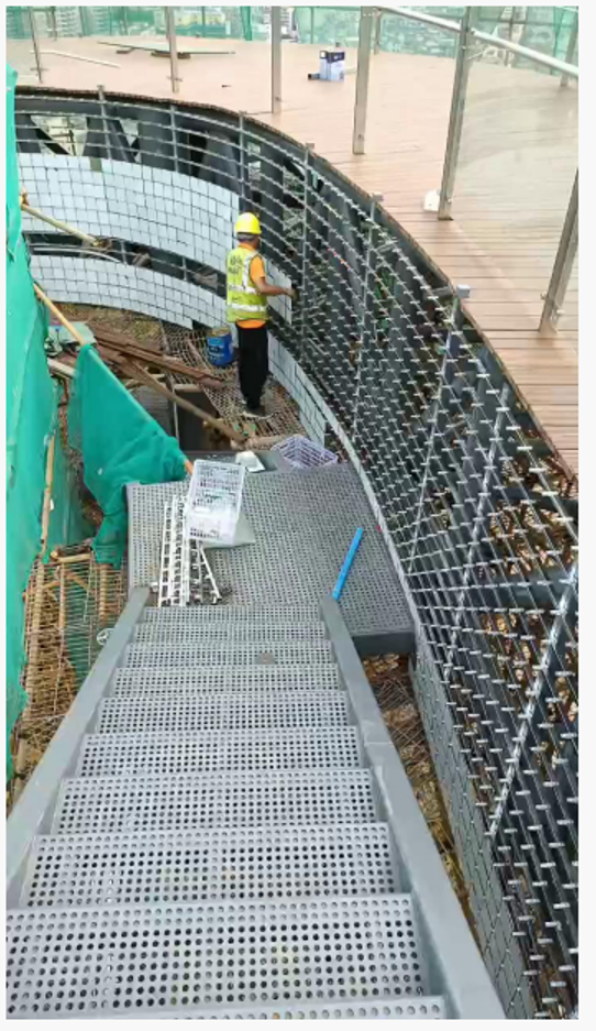 On-site installation of reflective kinetic facade panels on a curved public walkway